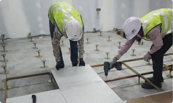 Installers working on raised floor panels