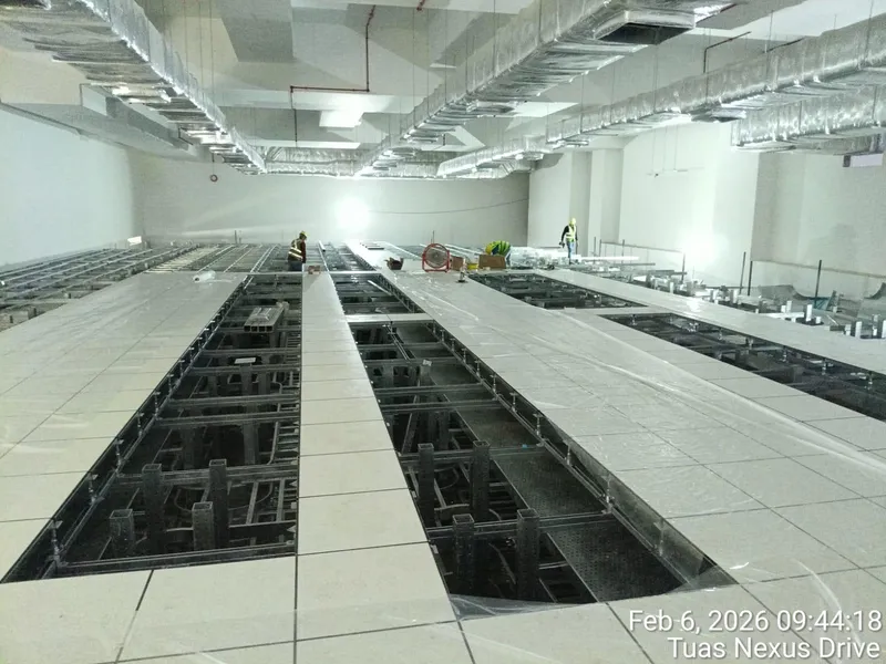 Completed raised floor with open bays revealing the underfloor cable layers at IWMF